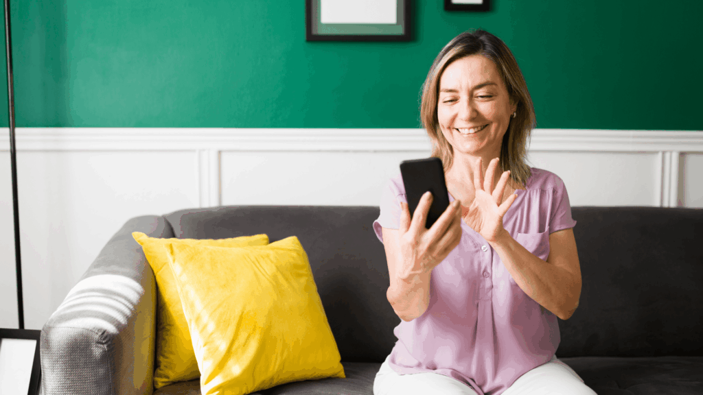 woman smiling at her phone