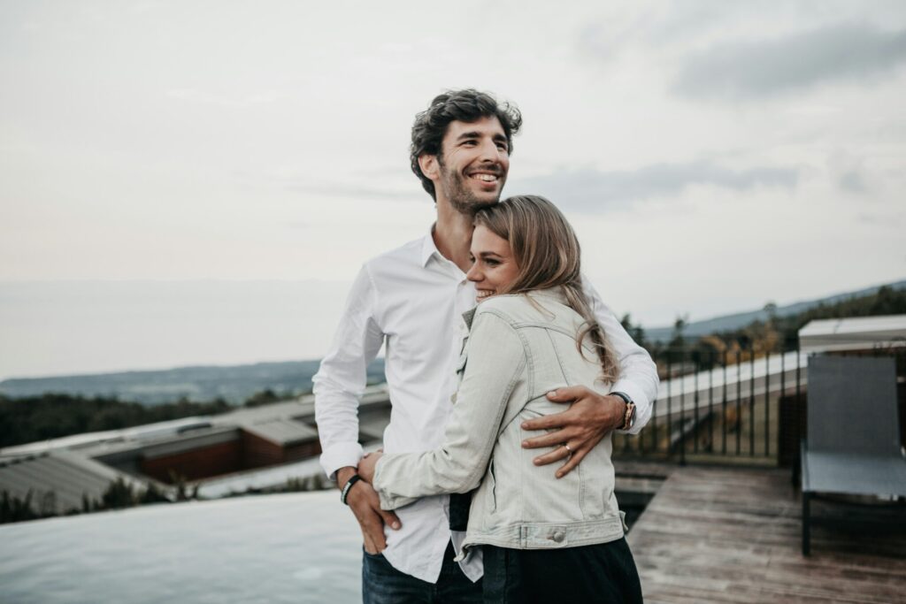couple hugging and smiling on a terrace